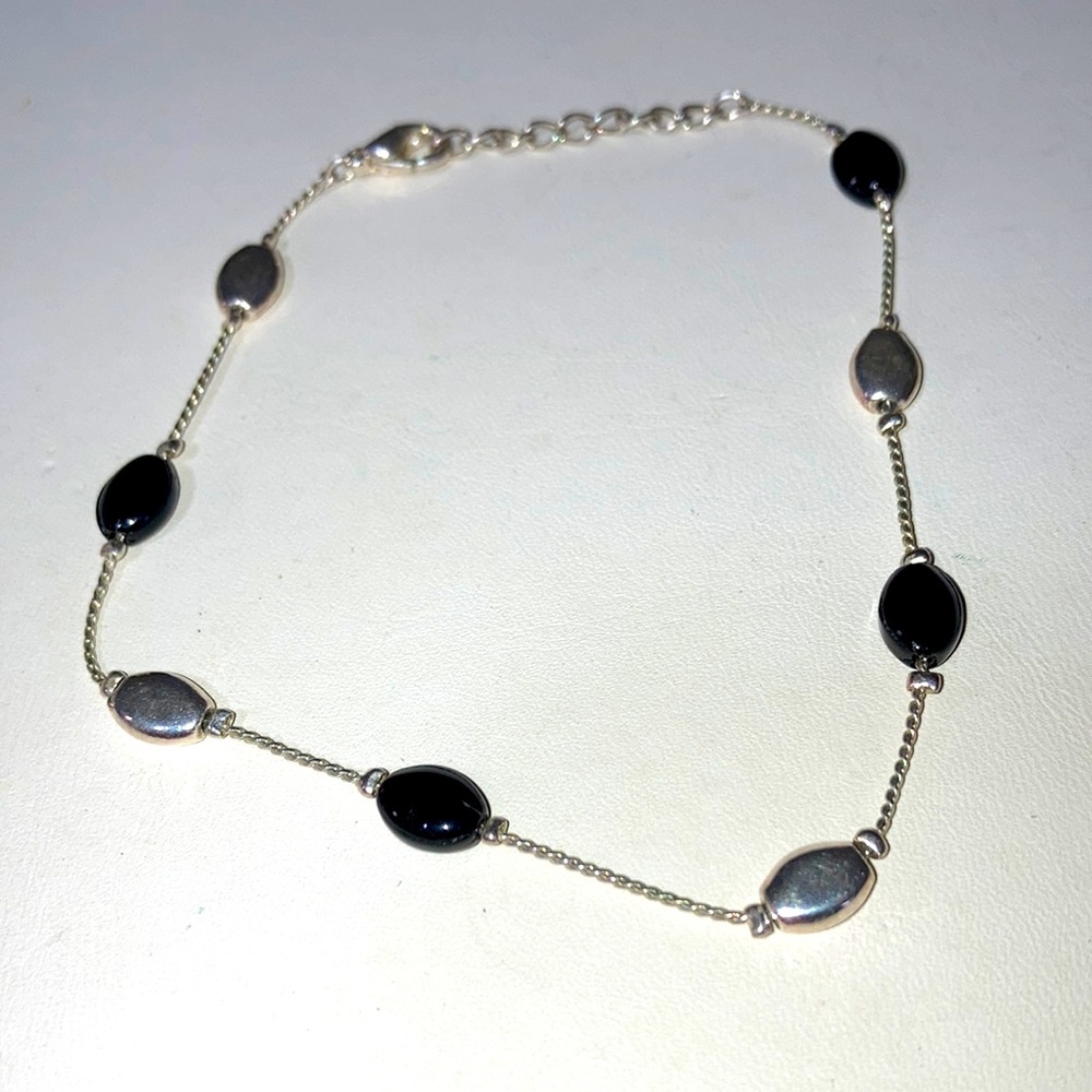 Silver tone and black ankle bracelet. Gently owned. Bme2570